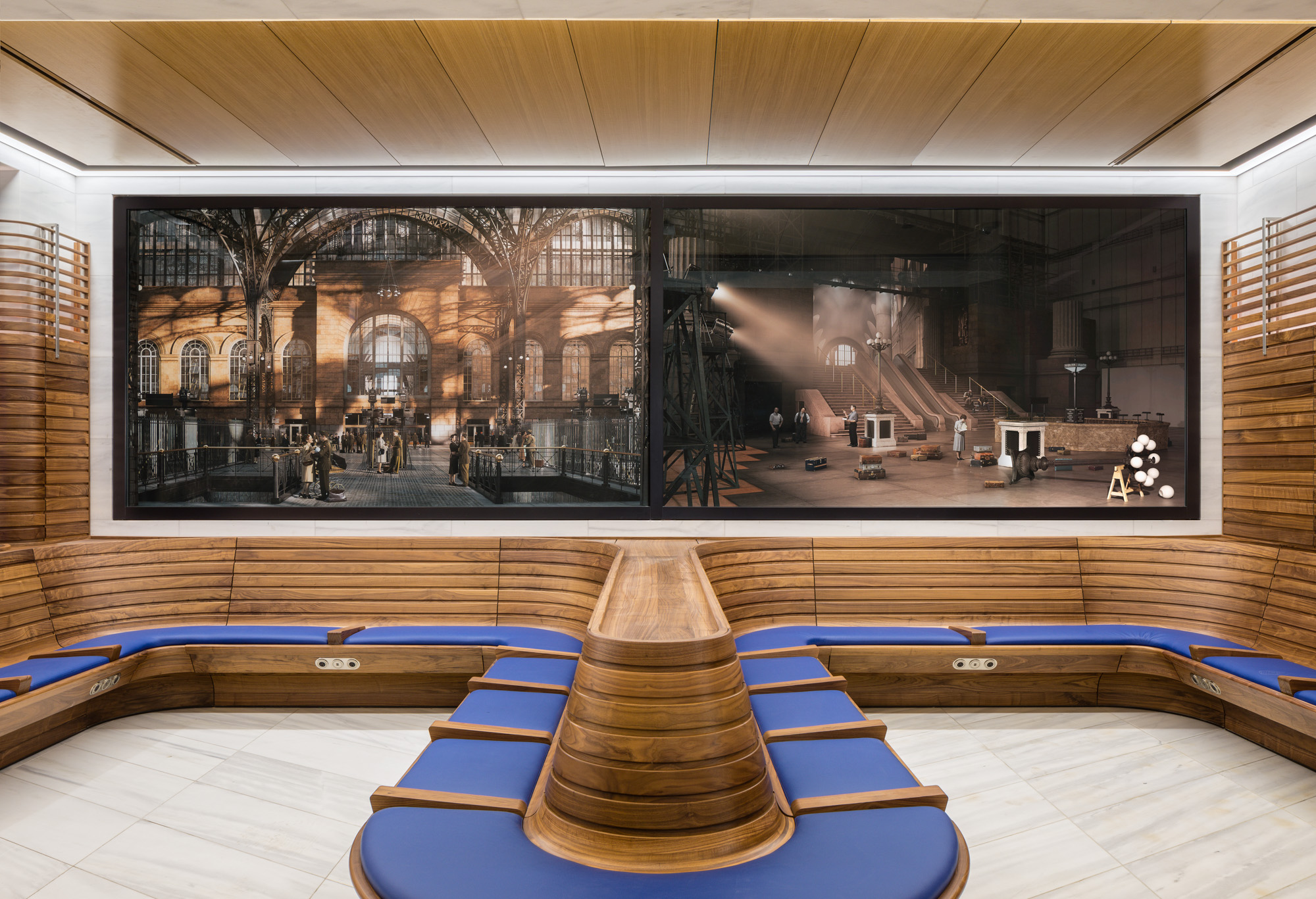 Two horizontal panels of photographs, with blue upholstery and wood seating below the panels. The two photographs depict reenactments of significant but little-known...