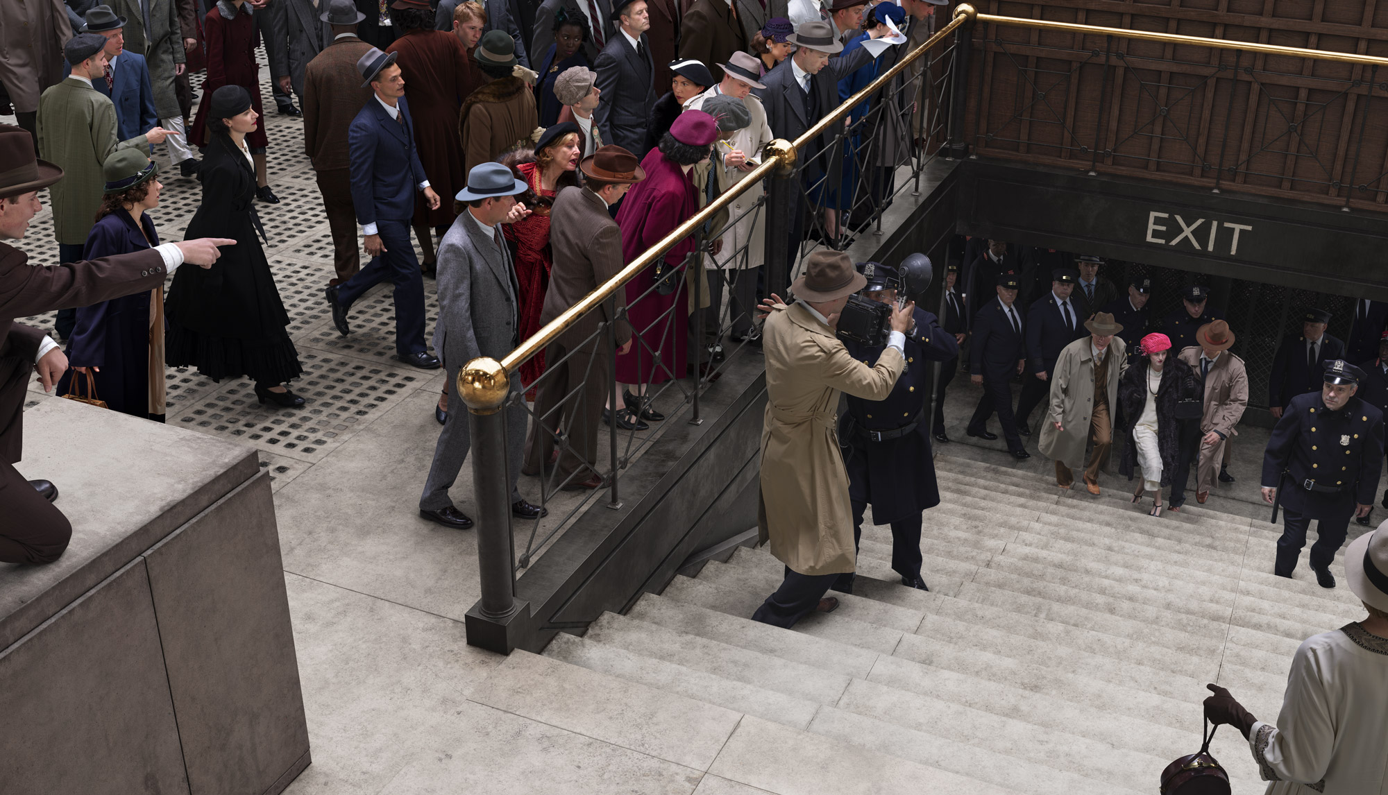 People dressed in winter fashions from the 1920s gather around the stairs to observe and photograph the emergence of an arrested woman.