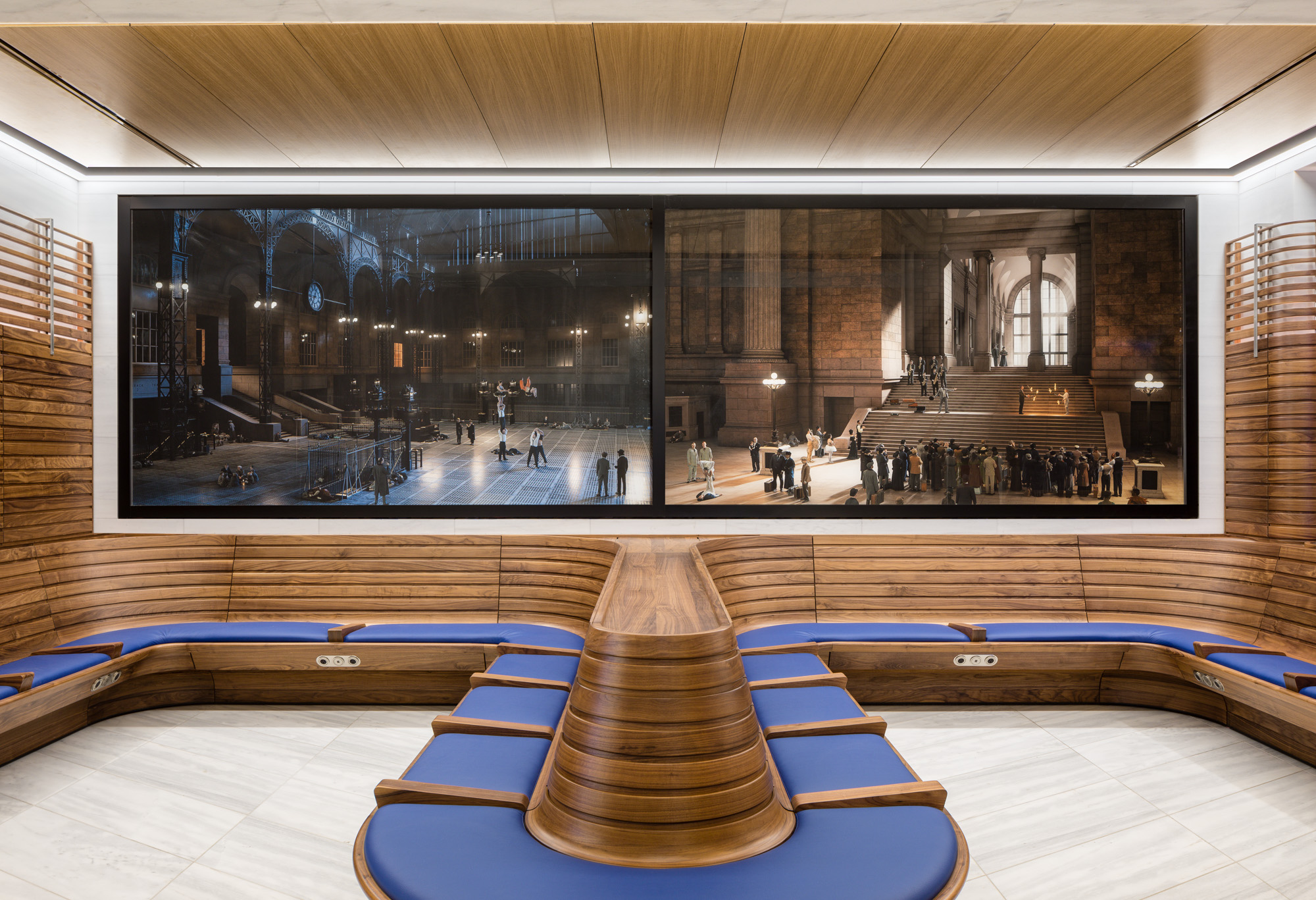 Two horizontal panels of photographs, with blue upholstery and wood seating below the panels. The two photographs depict reenactments of significant but little-known...