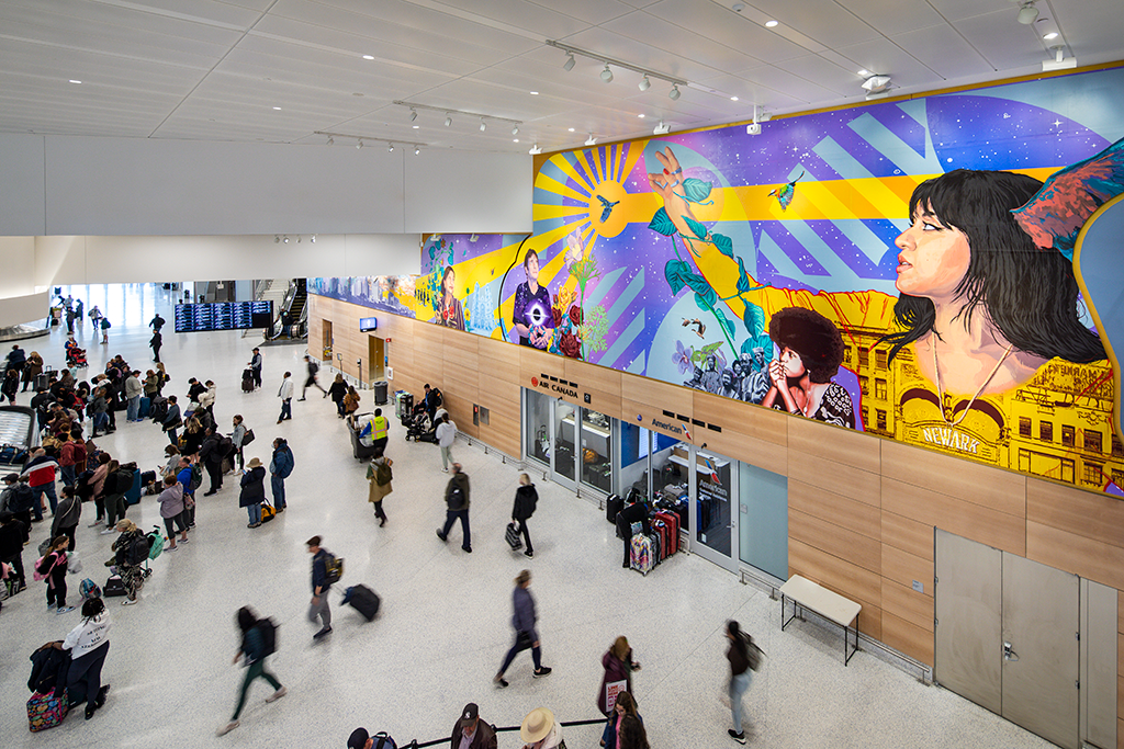 A brightly colored horizontal mural in an airport terminal featuring Newark Airport employees and notable historical icons in the New Jersey region, with a blue...