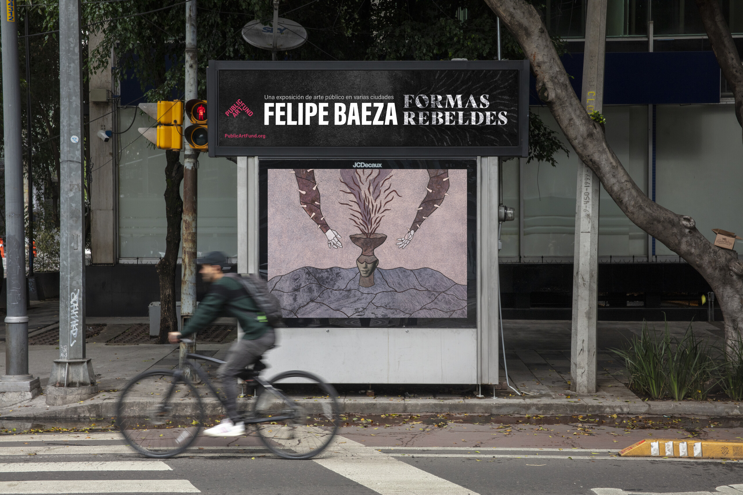 Pictured on a bus shelter on a busy city street is a layered hybrid figure that merges human, artifact, animal, and vegetation.