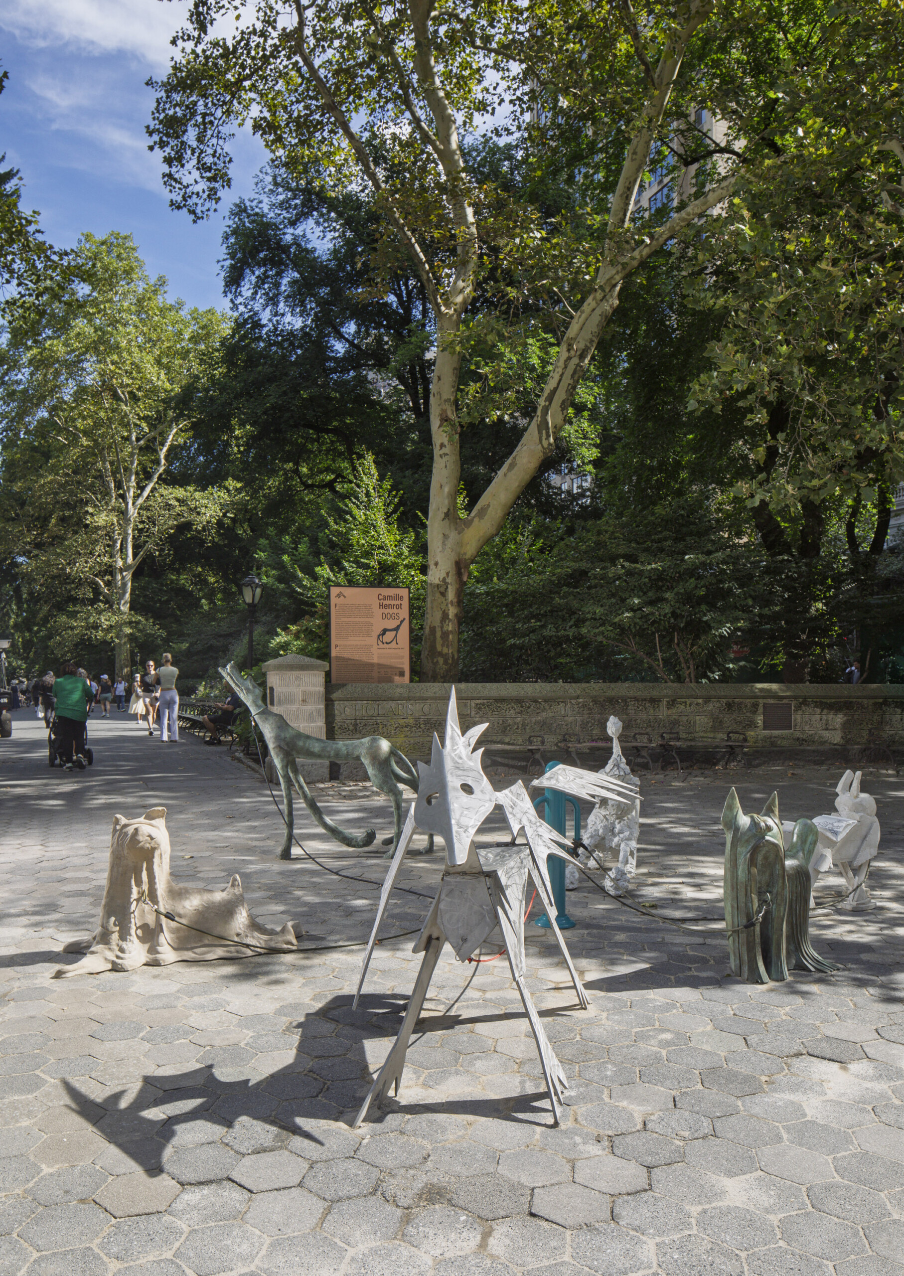 a group of dog sculptures in a plaza