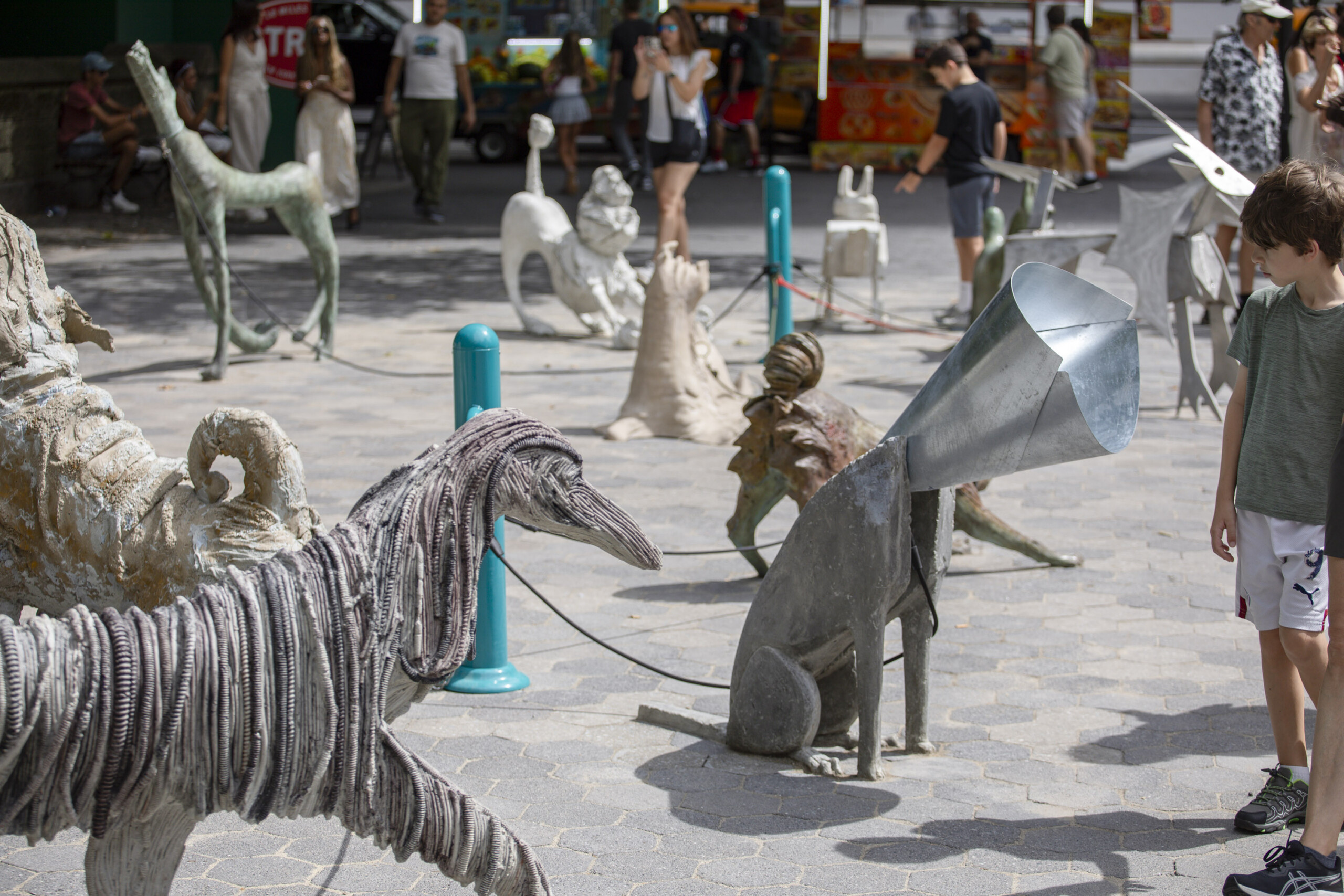 a group of dog sculptures in a plaza
