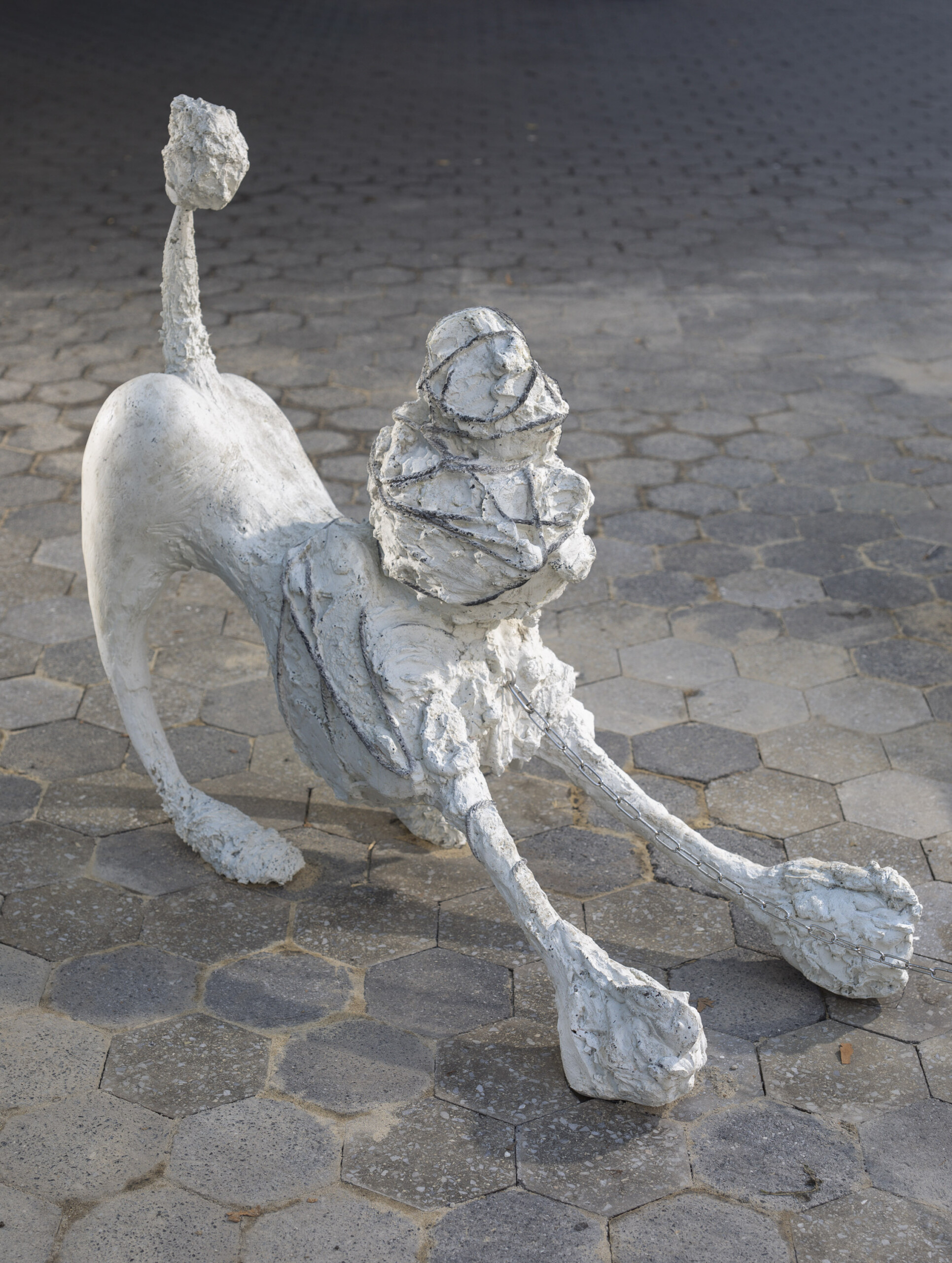 a white sculpture of a dog made of concrete, epoxy and mica